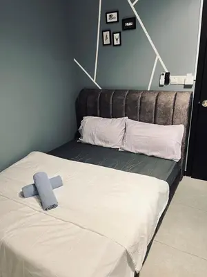 a bed with a blue towel on top of it at Neu Suites Studio Home Stay in Kuala Lumpur