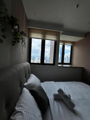 a bedroom with a bed with two towels on it at Reveria city KL in Kuala Lumpur