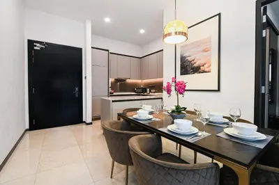 a dining room with a table and chairs and a kitchen at Atelier 118 Chinatown in Kuala Lumpur