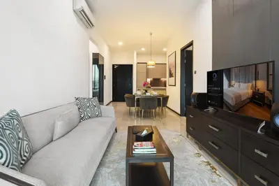 a living room with a couch and a tv and a table at Atelier 118 Chinatown in Kuala Lumpur