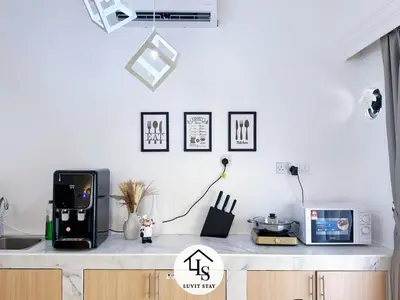 a kitchen with a counter top with a microwave at Holiday Place by Luvit Stay in Kuala Lumpur