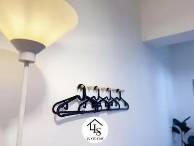 a rack of wine bottles on a wall next to a lamp at Holiday Place by Luvit Stay in Kuala Lumpur