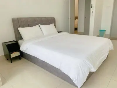 a large bed with white sheets and pillows in a bedroom at NEW Minimalist Cozy 3R3B SgBesi - 6 pax in Kuala Lumpur