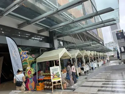 a group of people standing in front of a market at The Robertson Residence Kuala Lumpur by Alan in Kuala Lumpur