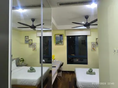 a bedroom with two beds and a ceiling fan at 0267 Sweet Home-Casa Residency 1R 1B in Kuala Lumpur