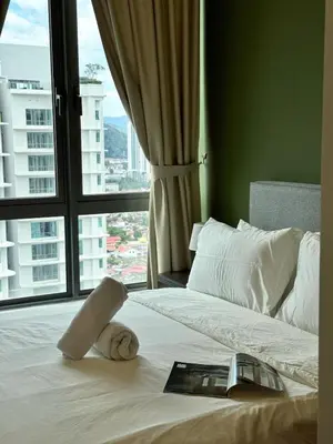a hotel room with a bed with a book on it at DRapport APT got Bathtub & Kids Game by Iconique in Kuala Lumpur