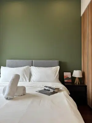 a bedroom with a bed with a book on it at DRapport APT got Bathtub & Kids Game by Iconique in Kuala Lumpur