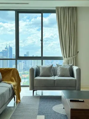 a living room with a couch and a large window at DRapport APT got Bathtub & Kids Game by Iconique in Kuala Lumpur