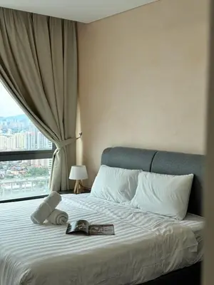 a bed with a book on it with a window at DRapport APT got Bathtub & Kids Game by Iconique in Kuala Lumpur