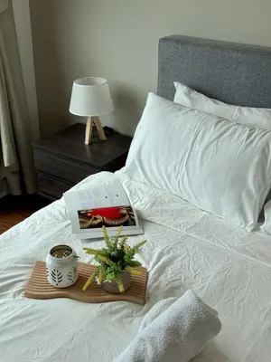a bed with a book and a plant on it at DRapport APT got Bathtub & Kids Game by Iconique in Kuala Lumpur