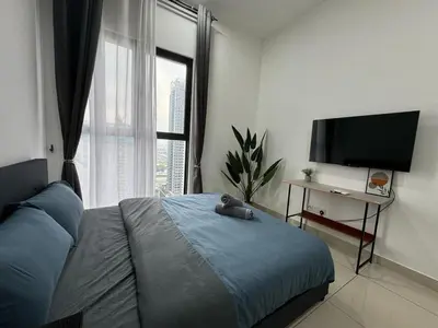 a bedroom with a bed with a teddy bear on it at Trion KL By HomeTaric Suite in Kuala Lumpur