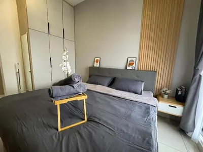 a bedroom with a large bed with a table on it at Trion KL, Jalan Chan Sow Lin, Kuala Lumpur by One Guesthouse in Kuala Lumpur