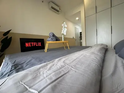 a bedroom with a bed and a table on it at Trion KL, Jalan Chan Sow Lin, Kuala Lumpur by One Guesthouse in Kuala Lumpur