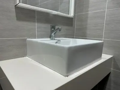 a bathroom with a white sink and a mirror at Trion KL, Jalan Chan Sow Lin, Kuala Lumpur by One Guesthouse in Kuala Lumpur