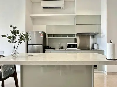 a kitchen with a large white counter in a room at Lucentia Apartments in Kuala Lumpur
