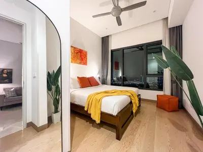 a bedroom with a bed and a large window at Lucentia Apartments in Kuala Lumpur