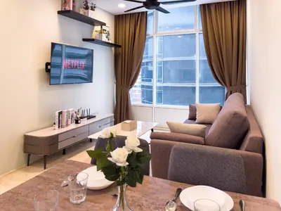 a living room with a couch and a table at Sky Suites KLCC Premium Stay in Kuala Lumpur