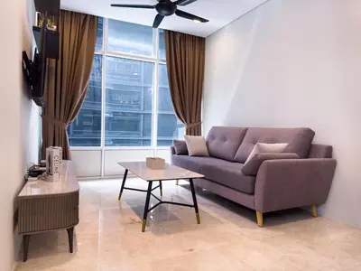 a living room with a couch and a table at Sky Suites KLCC Premium Stay in Kuala Lumpur