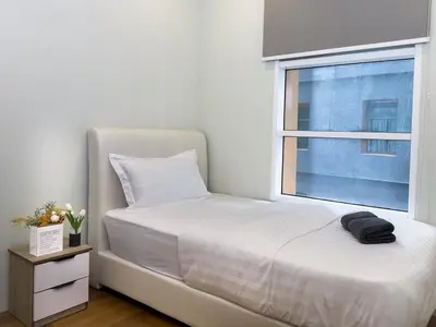 a bedroom with a white bed and a window at Sky Suites KLCC Premium Stay in Kuala Lumpur