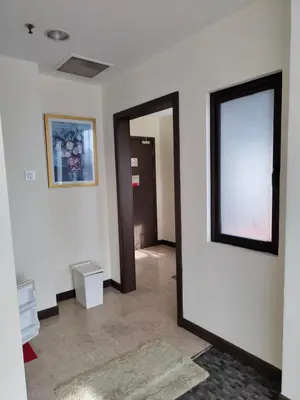 a hallway with an open door to a room at Services Star Hotel Suites At Times Square in Kuala Lumpur
