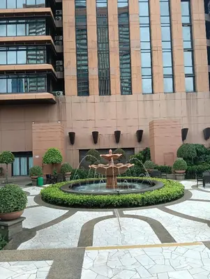a fountain in a courtyard in front of a building at Services Star Hotel Suites At Times Square in Kuala Lumpur