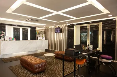 a lobby with a bar with a desk and chairs at M Design Hotel @ Shamelin Perkasa in Kuala Lumpur