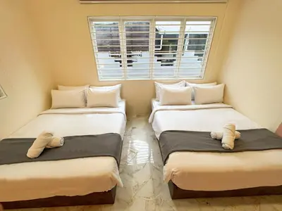 two beds in a small room with a window at Private Pool SemiD 5 Min Walk SunwayVelocity Max 21 Pax in Kuala Lumpur