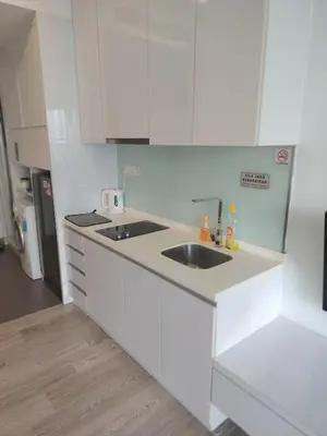 a white kitchen with a sink and a counter at One bukit ceylon Mardeka Tower View in Kuala Lumpur