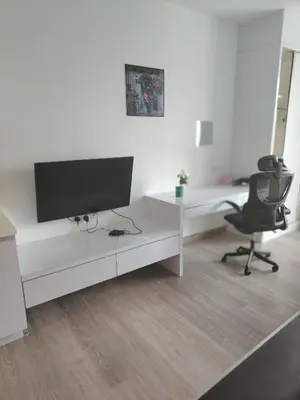 a white office with a desk and a monitor and a chair at One bukit ceylon Mardeka Tower View in Kuala Lumpur