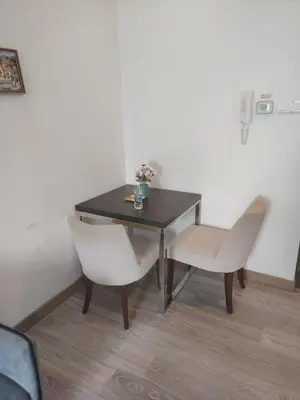 a dining room table with two chairs and a table at One bukit ceylon Mardeka Tower View in Kuala Lumpur