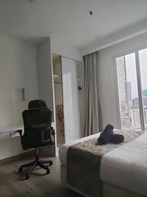 a hotel room with a bed and a desk and a chair at One bukit ceylon Mardeka Tower View in Kuala Lumpur
