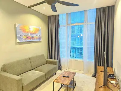 a living room with a couch and a large window at The Sky Suites KLCC by the Park in Kuala Lumpur
