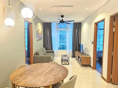 a living room with a table and a couch at The Sky Suites KLCC by the Park in Kuala Lumpur