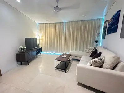 a living room with a white couch and a television at Vortex Suites KLCC by Angel in Kuala Lumpur