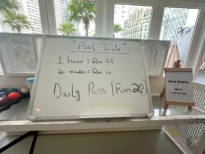 a sign sitting on a shelf in a room with windows at Vortex Suites KLCC by Angel in Kuala Lumpur