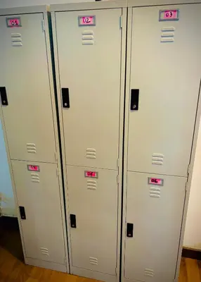 three lockers in a room with pink signs on them at Regalia Skypool KLCC Friendly Hostel in Kuala Lumpur