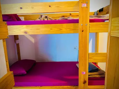 a bunk bed in a room with purple bunk beds at Regalia Skypool KLCC Friendly Hostel in Kuala Lumpur