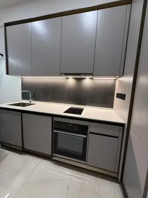 a kitchen with stainless steel cabinets and a sink at Opus Residence in Kuala Lumpur