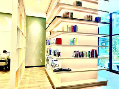 a book shelf filled with books in a library at The KLCC At Star SKY Pools in Kuala Lumpur