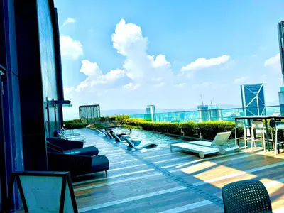 a balcony with couches and chairs on a building at The KLCC At Star SKY Pools in Kuala Lumpur