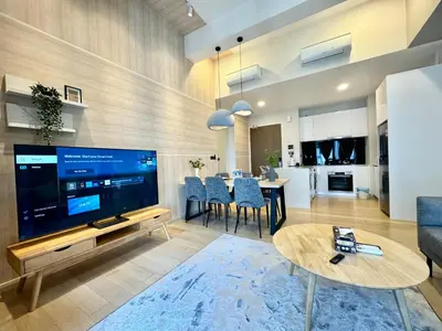 a living room with a large television and a dining room at The KLCC At Star SKY Pools in Kuala Lumpur
