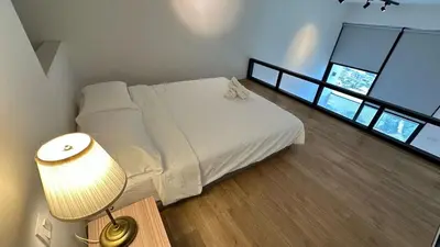 a bedroom with a white bed and a lamp at The Establishment Bangsar #19 by Ouki in Kuala Lumpur
