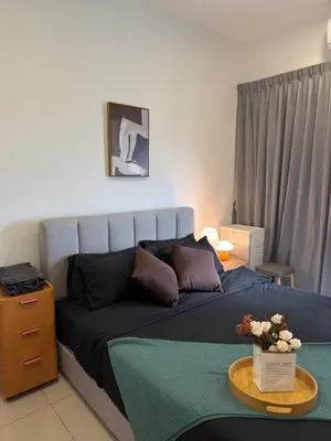a bedroom with a bed and a table with flowers on it at Razak Residence KL Area Cozy & Simple RC B2 18 in Kuala Lumpur