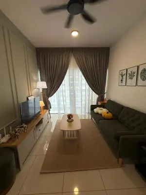 a living room with a green couch and a television at Razak Residence KL Area Cozy & Simple RC B2 18 in Kuala Lumpur
