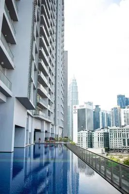 a view of the city from a swimming pool in a building at MyHabitat Residences in Kuala Lumpur