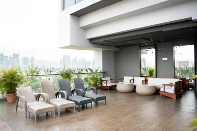 a lobby of a building with chairs and tables at MyHabitat Residences in Kuala Lumpur
