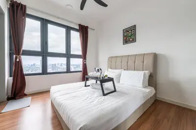 a bedroom with a large bed with a table on it at Kuala Lumpur Skyline CityView Comfort Home in Kuala Lumpur