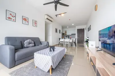 a living room with a couch and a tv and a table at Kuala Lumpur Skyline CityView Comfort Home in Kuala Lumpur
