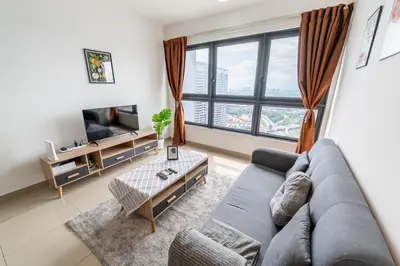 a living room with a couch and a tv at Kuala Lumpur Skyline CityView Comfort Home in Kuala Lumpur