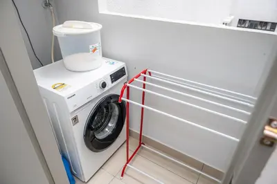 a white washer and dryer in a room at Kuala Lumpur Skyline CityView Comfort Home in Kuala Lumpur